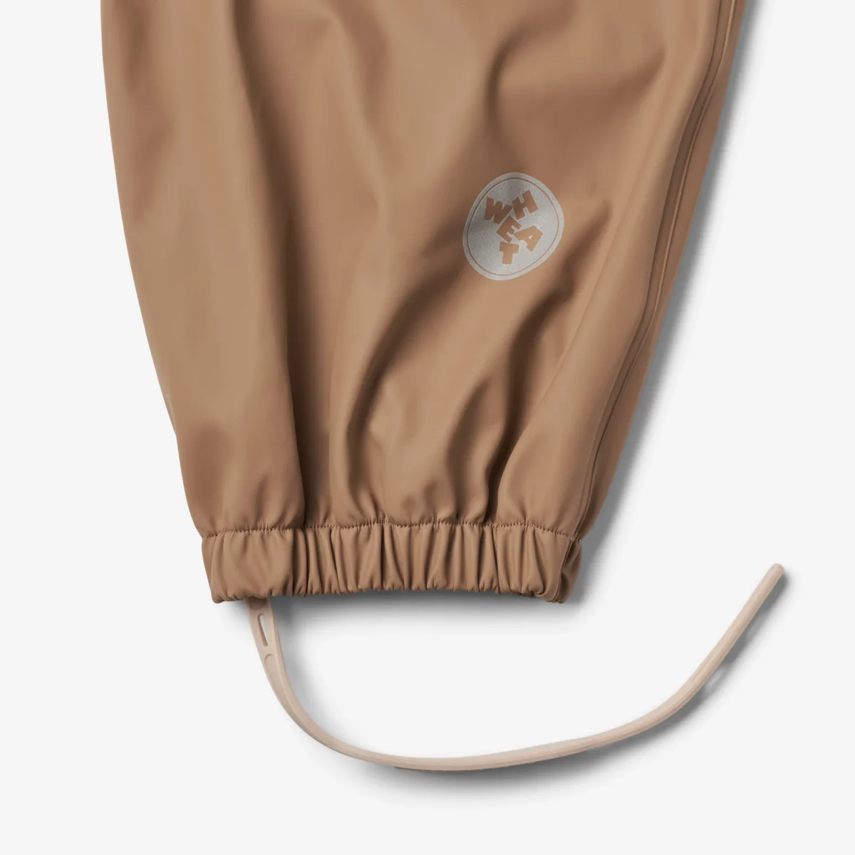 Wheat Rainwear Charlo traksidega vihmapüksid, hazel Wheat Rainwear Charlo traksidega vihmapüksid, hazel Lasteriided - HellyK - Kvaliteetsed lasteriided, villariided, barefoot jalatsid